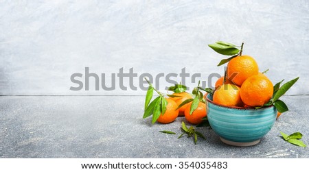 Similar – Foto Bild Orangefarbene Mandarinen in Keramik-Ornamentschale auf Holztisch