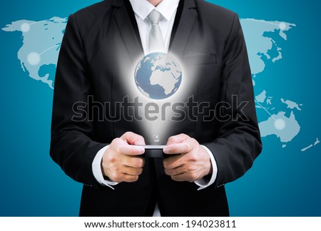 Businessman standing posture hand hold mobile phone Global Marketing isolated on blue background