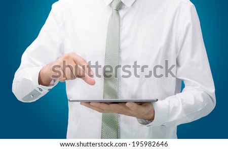 Businessman standing posture hand holding blank tablet isolated on blue background