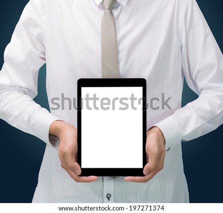 Businessman standing posture hand holding blank tablet isolated on dark background