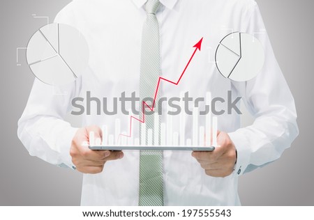 Businessman standing posture hand graph on tablet isolated on gray background