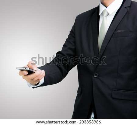 Businessman standing posture hand hold phone isolated on over gray background