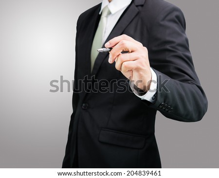 Businessman standing posture hand hold a pen isolated on over gray background