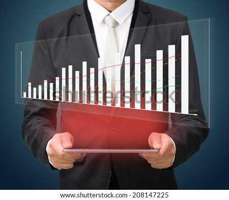 Businessman standing posture hand hold graph on tablet isolated on dark background