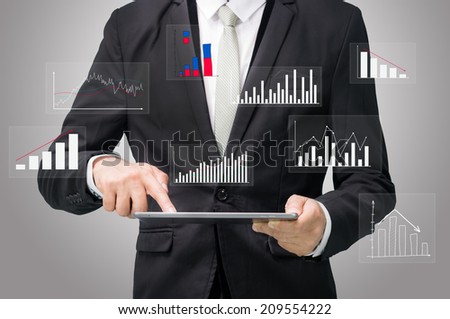 Businessman standing posture hand hold graph on tablet on gray background