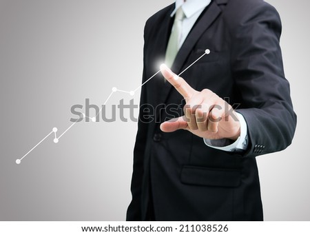 Businessman standing posture hand touch graph finance on over gray background