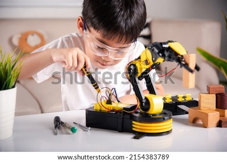 Similar – Image, Stock Photo Boy child using screwdriver at home