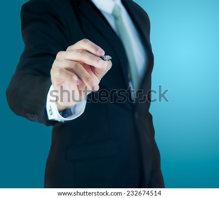 Businessman standing posture hand hold a pen isolated on over blue background