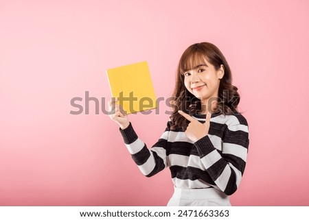 Similar – Image, Stock Photo Hand holds a yellow arrow with the word luck on it against a neutral turquoise background. Way to happiness.