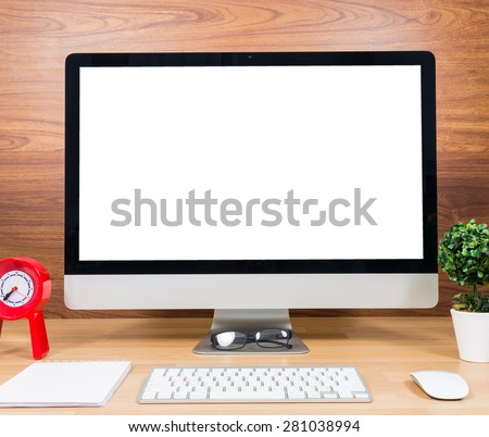 Office monitor computer, mouse on wood table and wooden wall background