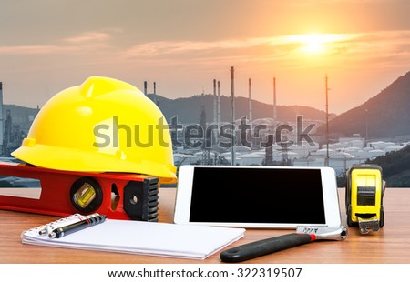 Working table engineer with tablet and tools in oil refinery industry business plant
