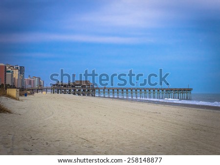 Atlantic Ocean Seaside. Wide sandy beaches of the Grand Strand with an ocean pier. Myrtle Beach, South Carolina.