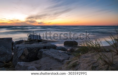 Lake Michigan Sunset. The sunset along the coast of Lake Michigan in Ludington State Park. Ludington is often voted as Michigan\'s top state park and one of the most popular in America.