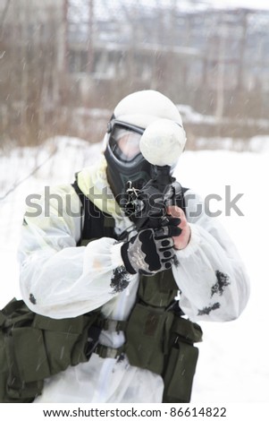 armed men in a camouflage play a paintball