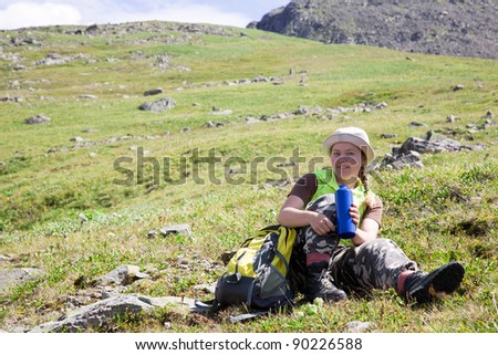 mountains tourist drinking water from bottle at mountain peak