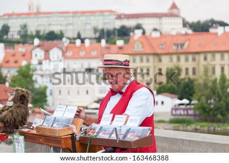 PRAGUE, CZECH REPUBLIC - JULY 30: Man offers music from hand operated music box in exchange for money on Charles Bridge on July 30, 2013 in Prague, Czech Republic
