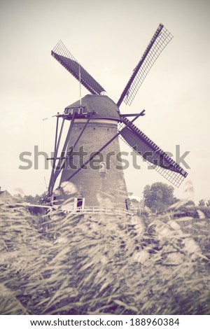 Old mill in Holland, stylization under an old card