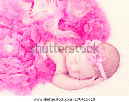 sleeping newborn girl in pink laces