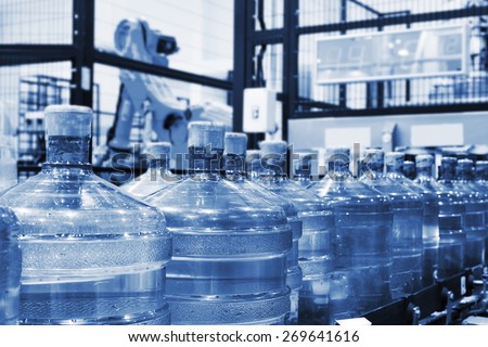 conveyor line on packing of drinking water in big plastic large bottles