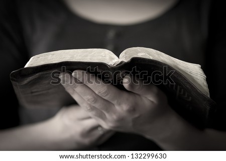 A close-up of a christian woman reading the bible.