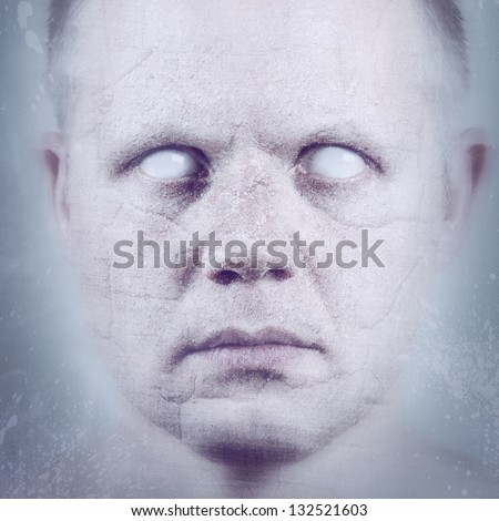 Scary man with white eyes in ice / stone.