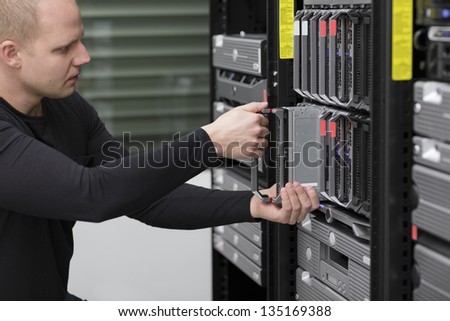 IT technician / engineer install / removes / replace a server in a data center.