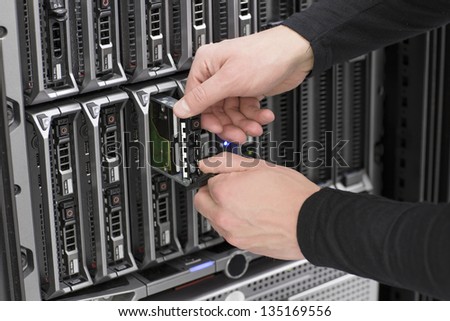 It engineer / technician working in a data center. Replace a local hard drive in a blade serevr.