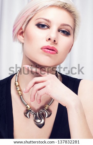 A beautiful and confident girl with creative hair style and attitude. Toned and natural retouched.