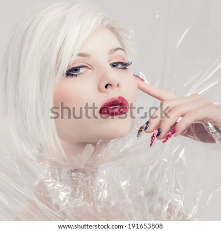 Posing blonde fashion model in plastic