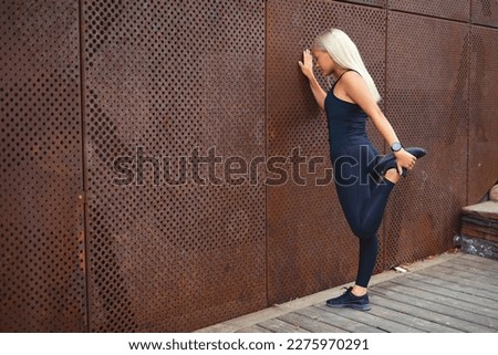 Similar – Woman stretching after running