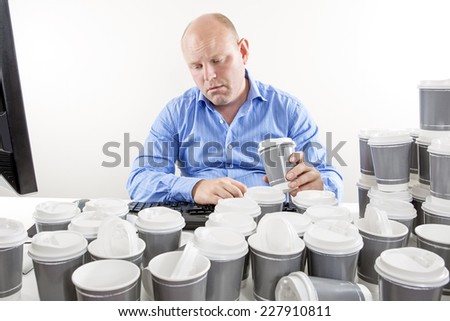 Overworked businessman drinking too much coffee