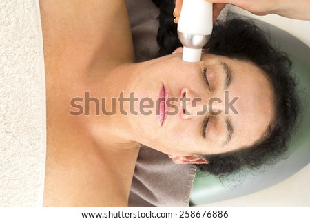 Woman receives diamond peeling at beauty clinic