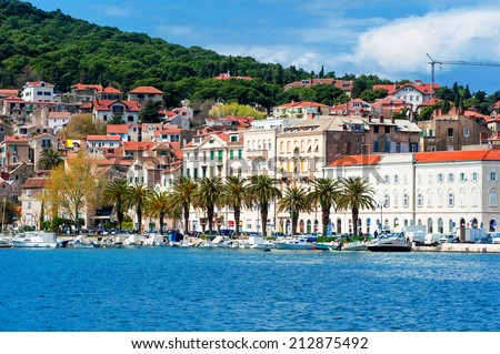 SPLIT, CROATIA - APRIL 8: Residents and tourists walking along the shore in the largest city on the coast in Croatia, Split with historical part of town in the background on April 8, 2013.