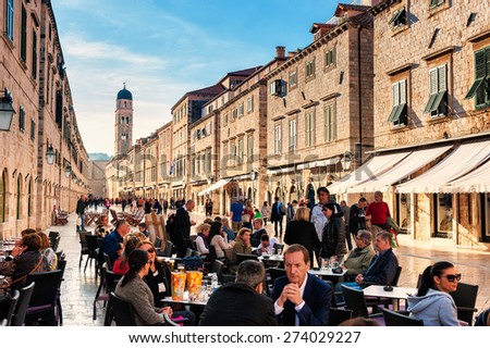 DUBROVNIK, CROATIA - APRIL 10: Tourists enjoy the terraces of restaurants in the old town of Dubrovnik on the main street Stradun on April 10, 2015.