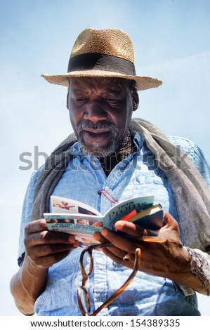 London, United Kingdom - July 7, 2013 : Music lover checks the schedule of the Proms which is orchestral classical music concerts and other events held annually in the Royal Albert Hall in London