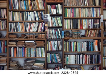 AYVALIK, TURKEY - AUGUST 09, 2014: Bookshelf with full of second hand books in a local shop in Ayvalik, Turkey