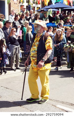 HASTINGS, UK - MAY 04, 2015: Man in costume walks with his cane during the parade of traditional Jack in the Green Festival in Hastings UK.