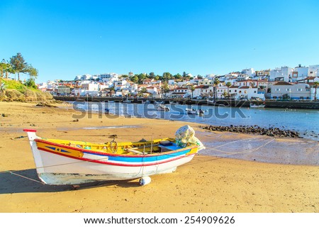 Boats in warm sunset light on the beach in Portimao, Portugal
