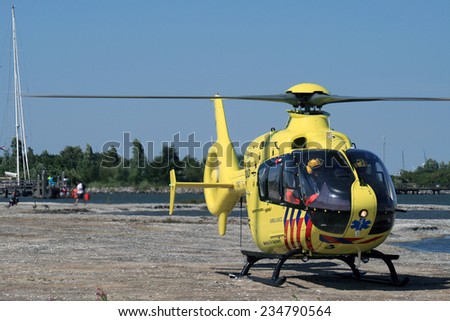MEDEMBLIK ,NETHERLANDS - AUGUST 12, 2013: Medical dutch rescue helicopter ready for takes off on 12 augustus  ,2012 in Medemblik, Netherlands.