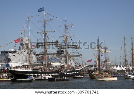 AMSTERDAM, THE NETHERLANDS, 20 AUGUST 2015 : Small recreation boats with people sailing along the great tall shipsduring the great nautical event SAIL 2015  on August 20, 2015 Amsterdam , Holland.