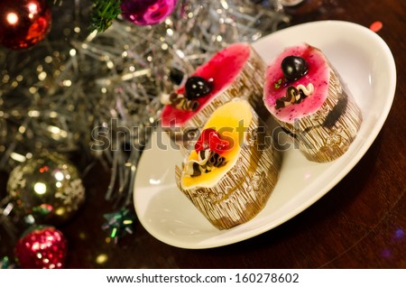 fancy cake on plate with christmas tree in background