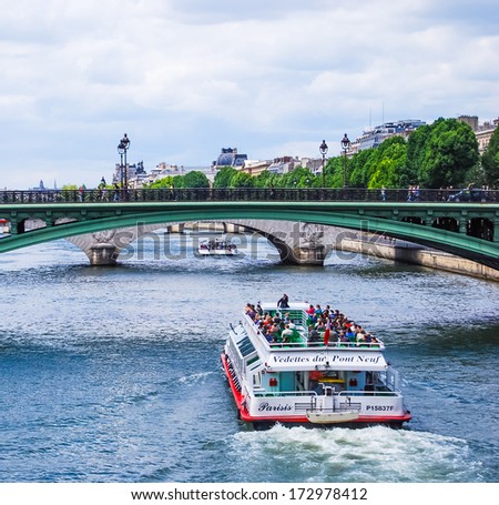 PARIS, FRANCE - JUNE 7: Seine, bridge Notre-Dame, and tourist boat, on June 7, 2009 in Paris, France. The Pont Notre-Dame is a bridge that links the quai de Gesvres with the quai de la Corse.