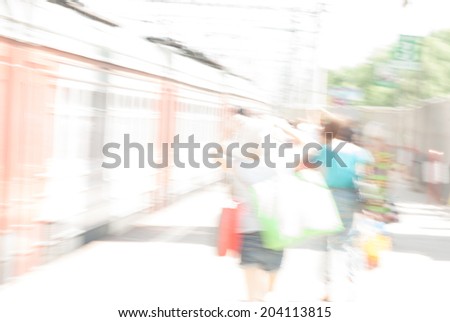 City commuters. High key blurred image of people on train station. Unrecognizable faces, bleached effect.