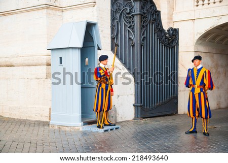 VATICAN CITY, ITALY- AUGUST 26 : Swiss guardsmen stands in front of Vatican Museum on August 26, 2014 in Vatican, Rome, Italy. The Swiss Guards are responsible for the security of Vatican.