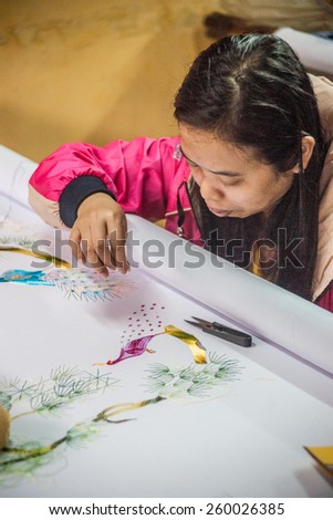 HOI AN, VIETNAM - FEBRUARY 5, 2015: Vietnamese woman produces hand-made embroidery, in Hoi An, Feb 5, 2015.