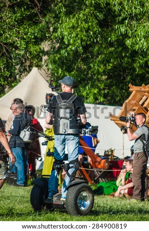 MOSCOW - JUNE 06, 2015: Cameraman on Steadiseg shooting historical reenactment in Kolomenskoye, Moscow. Steadiseg is easy way to capture smooth tracking shots at a fairly brisk pace.