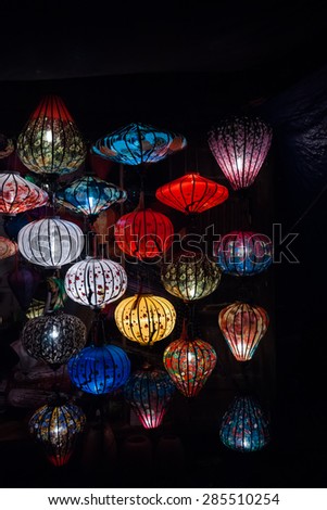 Night lanterns in old Hoi An town in Vietnam. Background of ancient eastern culture. Multiple colors and bright lights.