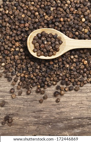 black peppercorns on wooden table