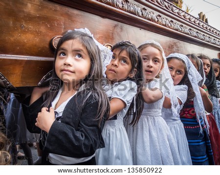 ANTIGUA, GUATEMALA - MARCH 9: Unidentified children participate in an Easter procession on March 9, 2013 in Antigua, Guatemala. The street procession celebrates Easter or \