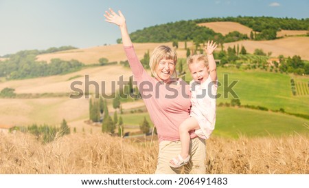 Family on holiday in Tuscany, mother and daughter are watching the landscape, Italy